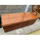 A G-PLAN STYLE RETRO TEAK UNIT ENCLOSING TWO CUPBOARDS AND TWO DRAWERS, 54" WIDE
