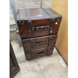 A LEATHER THREE DRAWER CHEST IN THE FORM OF SUITCASES