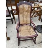 A VICTORIAN BEECH ROCKING CHAIR WITH SPLIT CANE BACK AND SLAT