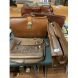 AN ASSORTMENT OF VINTAGE AND LEATHER EFFECT BRIEFCASES