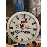 A METAL GUINESS WALL CLOCK