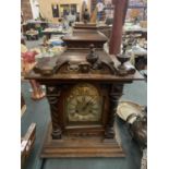 A LARGE WOODEN MANTEL CLOCK (FINIALS A/F) APPROXIMATE HEIGHT 60CM