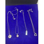FOUR SILVER NECKLACES MARKED 925 WITH PENDANTS TO INCLUDE A SILVER HEART, FLOWER, INGOT ETC