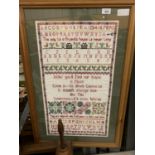 A LARGE WOODEN FRAMED EMBROIDERED SAMPLER