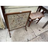 A 1950'S TAPESTRY FIRESCREENA ND HEAVILY CARVED ASIAN STYLE TABLE DEPICTING TRIBAL FIGURES