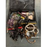 AN OLD CASH TIN CONTAINING AN ASSORTMENT OF COSTUME JEWELLERY