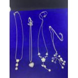 FOUR SILVER NECKLACES MARKED 925 WITH PENDANTS TO INCLUDE A DECORATIVE PEARL DESIGN, CLEAR STONE