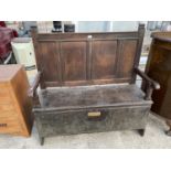 A VICTORIAN SETTLE WITH FOUR SECTION PANELED BACK AND HINGED SEAT