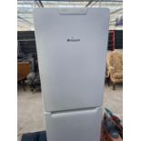 A LARGE WHITE HOTPOINT UPRIGHT FRIDGE FREEZER BELIEVED IN WORKING ORDER BUT NO WARRANTY