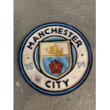 A CIRCULAR CAST METAL ' MANCHESTER CITY' SIGN 24CM