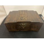 A CARVED WOODEN LIDDED BOX WITH BRASS CLASP