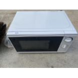 A WHITE TESCO ESSENTIAL MICROWAVE OVEN BELIEVED IN WORKING ORDER BUT NO WARRANTY
