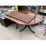 A MAHOGANY EXTENDING DINING TABLE ON TWIN PEDESTAL SUPPORTS