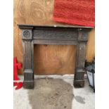 A VINTAGE WOODEN FIRE SURROUND