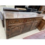 A GEORGE III BURR OAK DRESSER BASE ENCLOSING THREE PANELLED DOORS AND THREE FRIEZE DRAWERS, 71" WIDE