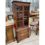 A REPRODUCTION MAHOGANY CABINET WITH GLAZED TWO DOOR UPPER PORTION, THREE DRAWERS AND SLIDE TO BASE,
