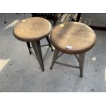 TWO CIRCULAR INDUSTRIAL STYLE STOOLS, STANDING ON POLISHED STEEL TAPERED LEGS