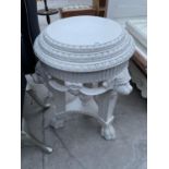 AN ELABORATE WHITE SIDE TABLE WITH LION'S HEAD DECORATION