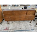 A RETRO TEAK SIDEBOARD WITH FOUR DOORS AND SIX DRAWERS