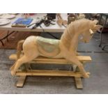 A VINTAGE WOODEN CARVED ROCKING HORSE - HEIGHT TO SADDLE 65CMS