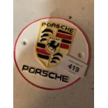 A CAST METAL ?PORSCHE? RACING CAR CIRCULAR SIGN