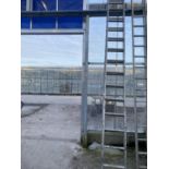 A LARGE EXTENDABLE ALLUMINIUM LADDER (16 RUNGS PER SECTION)