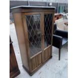 A PRIORY STYLE OAK CABINET WITH TWO LEAD GLAZED DOORS