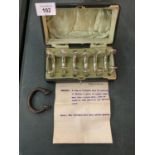A VINTAGE VELVET LINED BOX CONTAINING SEVEN MANILLAS, SIX OF WHICH HAVE BEEN SILVER PLATED