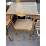 A SMALL PINE KITCHEN TABLE WITH LOWER DRAWER AND SPLASHBACK