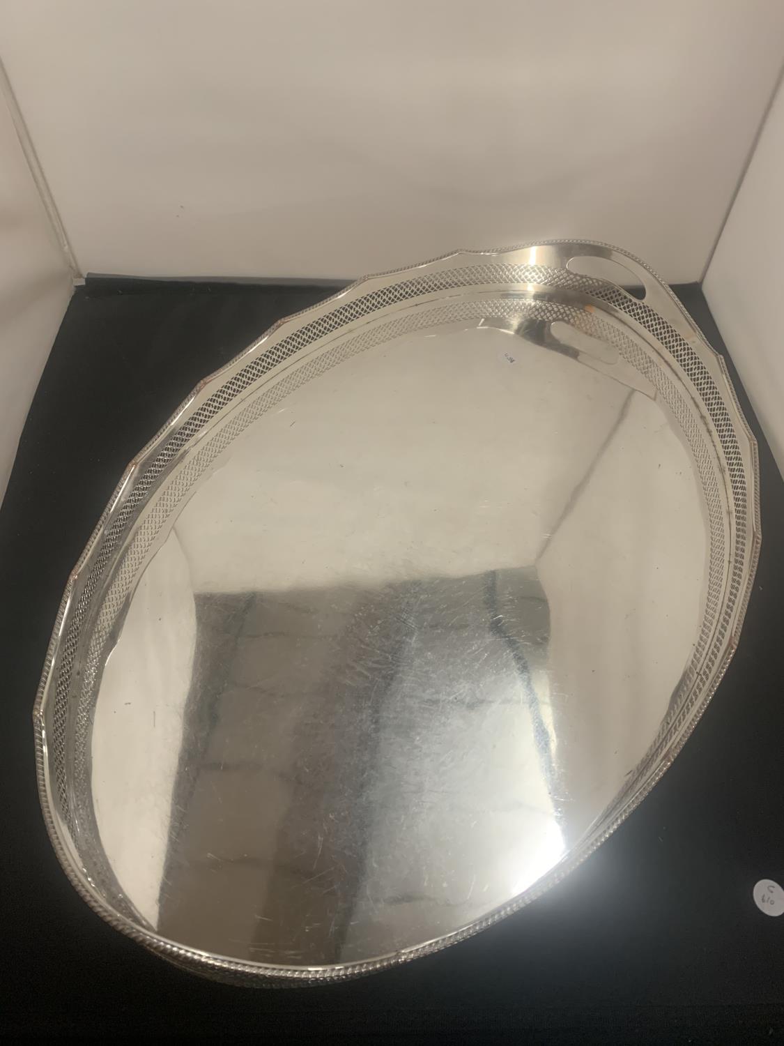 A LARGE OVAL SILVER PLATE BUTLERS TRAY 61CM X 41CM