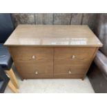 A MODERN OAK EFFECT CHEST OF FOUR DRAWERS