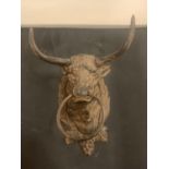 A CAST METAL BULL'S HEAD WITH NOSE RING FOR WALL MOUNTING