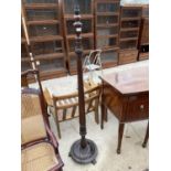 AN EDWARDIAN MAHOGANY STANDARD LAMP WITH REEDED COLUMN