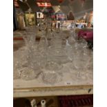 A VARIETY OF CUT GLASS WARE TO INCLUDE DECANTERS, VASES AND GLASSES ETC
