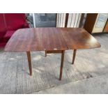 A RETRO TEAK DROP LEAF DINING TABLE