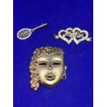 THREE BROOCHES TO INCLUDE TWO HEARTS AND MOTHER WITH CLEAR STONES, A TENNIS RACQUET WITH CLEAR