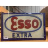 AN ILLUMINATED 'ESSO EXTRA' SIGN