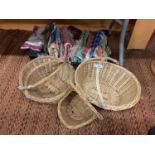 THREE WICKER BASKETS AND AN ASSORTMENT OF CLOTH