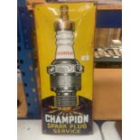 A RETRO METAL 'CHAMPION SPARK PLUG SERVICE' SIGN 70CM X 30CM