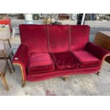 A MAHOGANY FRAMED THREE SEATER SOFA ON CABRIOLE SUPPORTS WITH RED VELVET STYLE UPHOLSTERY