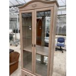 A LIMED OAK TWO DOOR DISPLAY CABINET