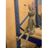 A LARGE WOODEN SHELF RABBIT