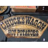 A METAL "CHUCK'S WAGON HOT POTATOES" SIGN