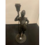 A VINTAGE SPELTER CANDLESTICK IN THE FORM OF A HISTORICAL FIGURINE