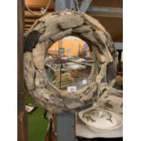 A ROUND PORT HOLE STYLE MIRROR IN A DRIFTWOOD FRAME