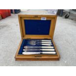 A SILVER PLATE CANTEEN OF FISH CUTLERY IN A WALNUT DISPLAY BOX