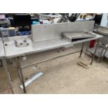 AN INDUSTRIAL PREP UNIT WITH SMALL SINK AND A SHELVING UNIT ETC
