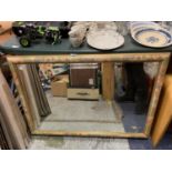 A LARGE FLORAL FRAMED MIRROR