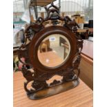 A VICTORIAN HEAVILY CARVED MAHOGANY BEVEL EDGED DRESSING TABLE MIRROR WITH LOWER SHELF