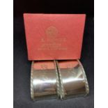 A PAIR OF NAPKIN RINGS MARKED 925 IN AN OMEGA BOX